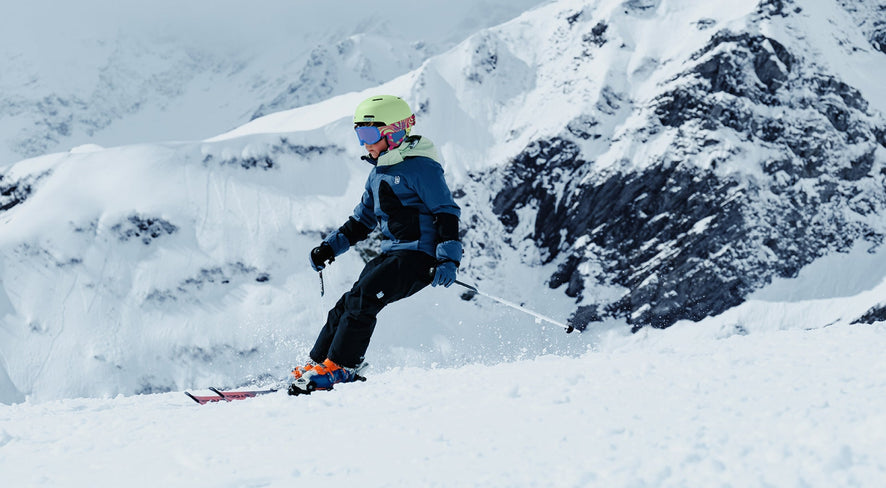 A boy is skiing down the mountain