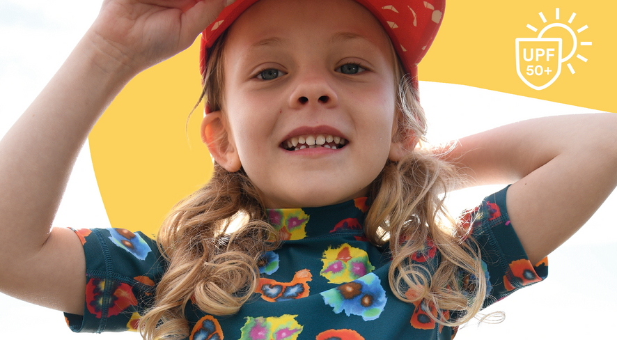 Kid in swimwear smiling at the camera