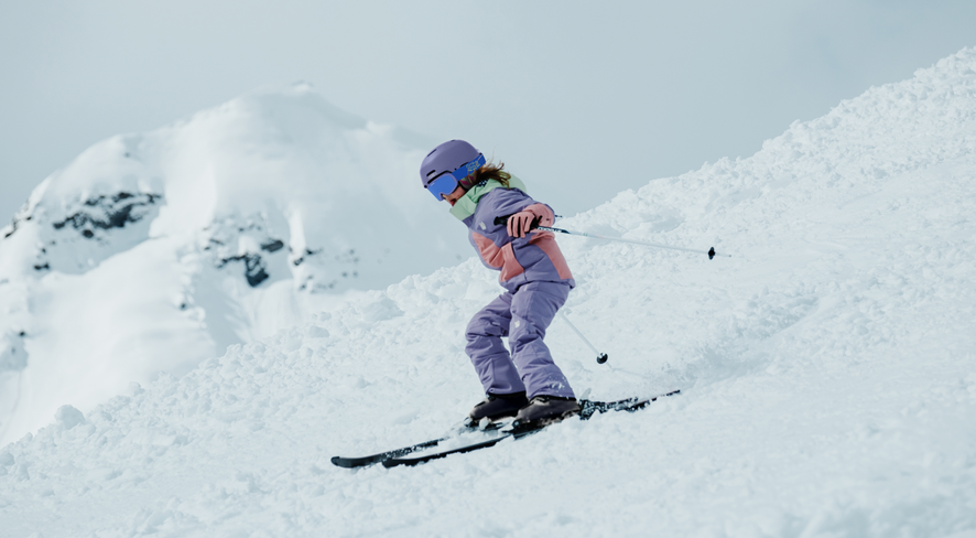 Girl skiing in the new snow jacket and snow pants from the children's clothing brand namuk