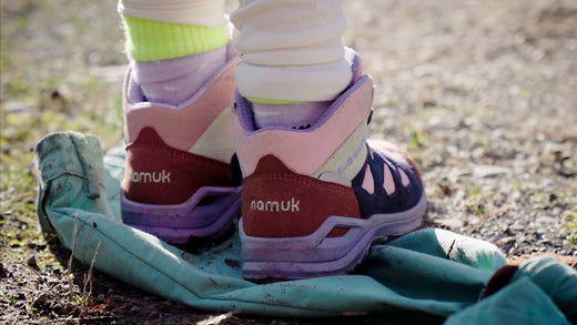 Child standing with hiking boots on namuk pants