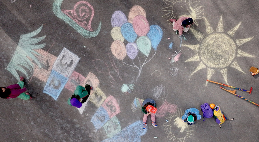 Kids are playing and painting in the street