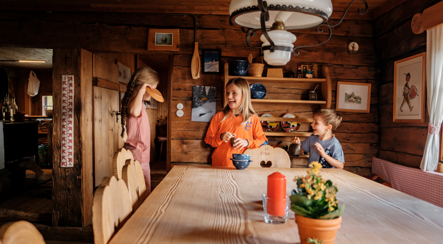 Happy children in an alpine hut.
