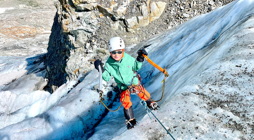 Kid ice climbing in namuk clothing