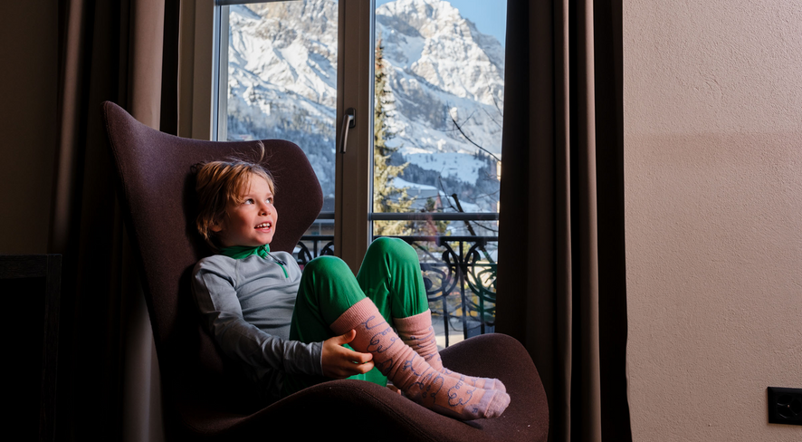 Kid in namuk merino thermal underwear sitting in a cozy chair