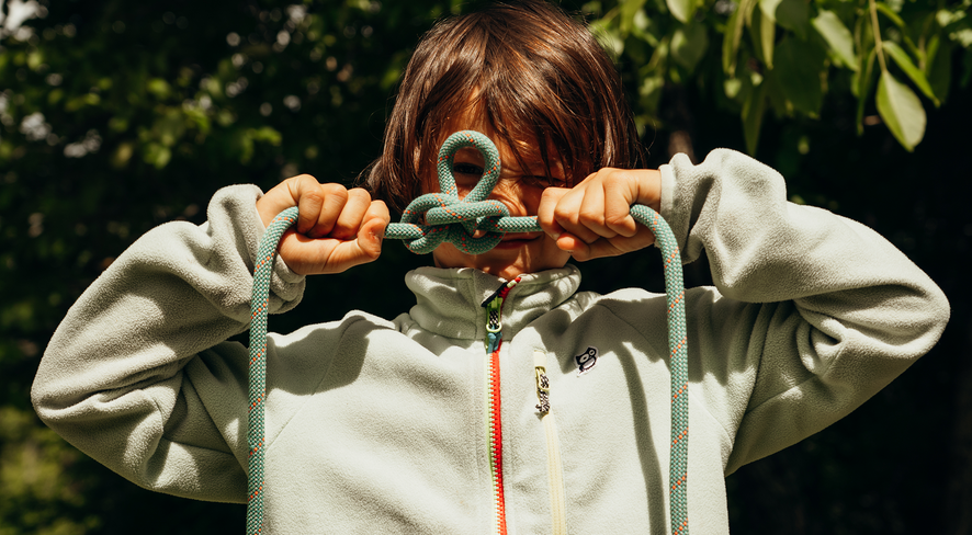 Arlo shows his finished alpine butterfly knot