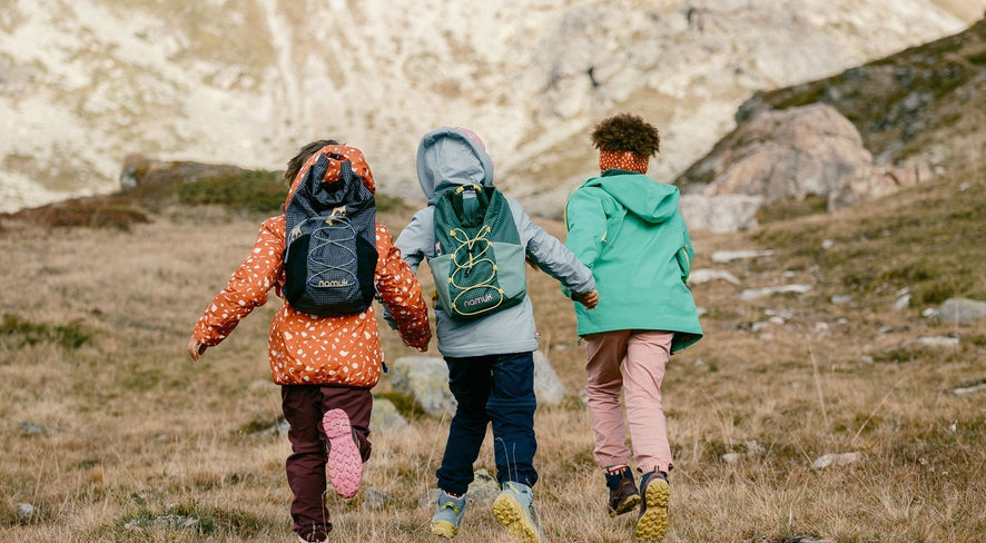 Kids running towards the mountains